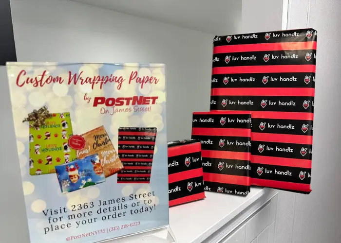 Boxes wrapped in wrapping paper with LuvHandlz branding