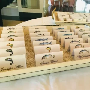 Name tags aligned on tray with illustration of fish on each one